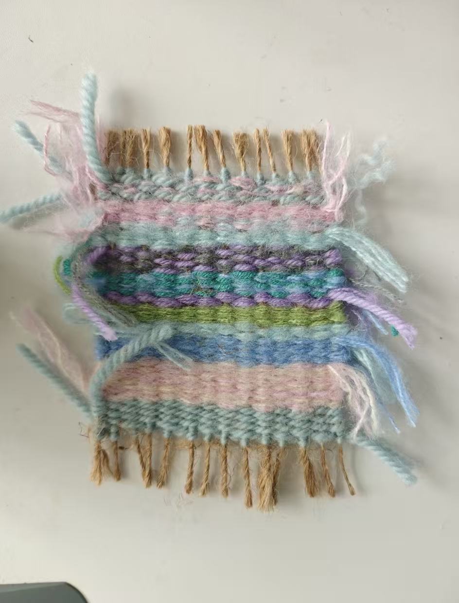 Colorful beginner woven sample with pastel yarn